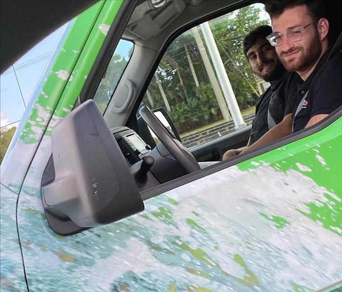 24/7 We are here for you! - Image of two men in SERVPRO vehicle.